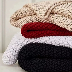 Nordic style chunky knit blanket with tassels in beige, red, white, and black colors