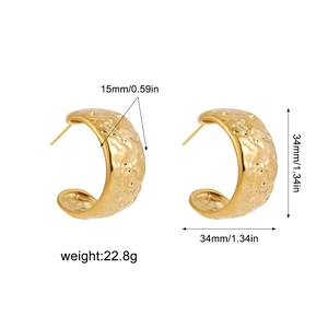 Macro view of 14K gold stainless steel chunky C-hoop earrings with hammered texture