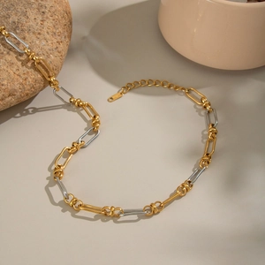 Detailed shot of two-tone gold and silver chain necklace with lobster clasp and extender