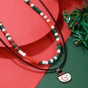 Close-up of a double-layered Christmas snowman necklace with red green and white beads