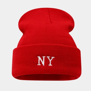 Close-up of premium red knit beanie showing detailed white NY letter embroidery