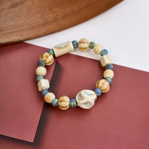 Macro shot of colorful glazed ceramic beads on a cord with intricate carved detail