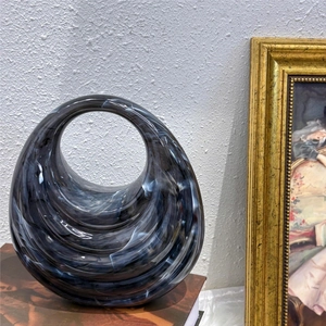 Close-up of wavy acrylic bag showing deep black and blue marble swirl textures