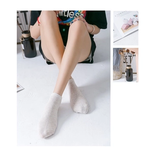 Close-up of light beige cotton low cut socks with cute cartoon puppy embroidery