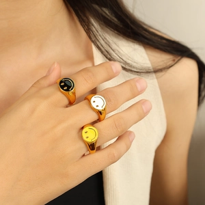 Gold-plated 18K titanium steel rings with colorful enamel smiley faces on model fingers