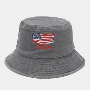 Detail of USA embroidery and American flag patch on washed cotton bucket hat with eyelets