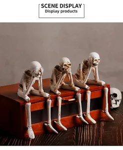 Detailed view of three spooky skeleton figurines sitting on a shelf for Halloween decor