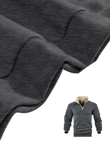 Detail of grey sweatshirt showing ribbed cuffs and beige fleece elbow patches texture