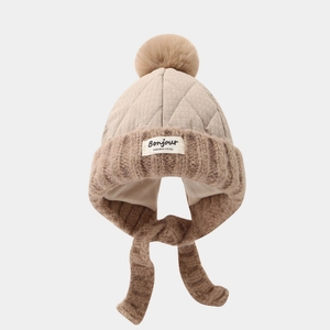 Detailed knit winter baby hat with pom-pom, quilted crown, ear flaps and Bonjour label