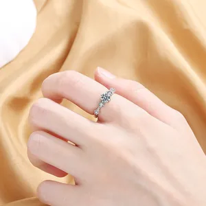 Close-up of star-shaped zircon ring on hand over satin fabric showing fine details