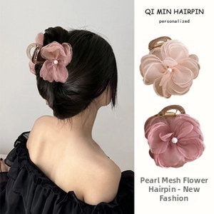 Detail showing elegant organza flower hair claw clip with a centered pearl decoration