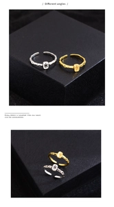 Detail of adjustable gold and silver lava texture rings with starburst engraving