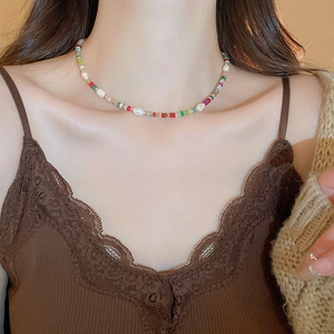 Gros plan d'un collier ras du cou en perles colorées et perles d'eau douce sur un mannequin