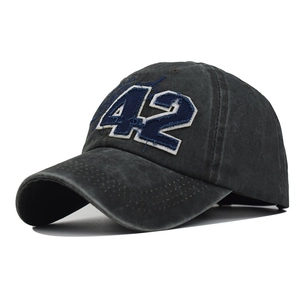 Detail of vintage washed cotton baseball cap with blue number 42 embroidery and frayed edges