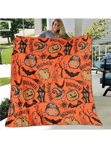 Macro detail of Halloween flannel blanket featuring pumpkin, bat and ghost patterns