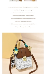 Close-up of retro color-block handbag with letter pattern, scarf handle and bear charm