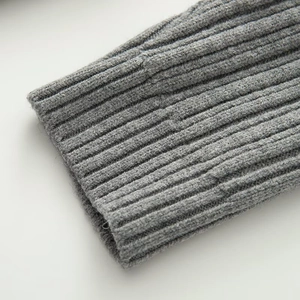 Detailed close-up of grey ribbed knit sweater cuffs showing soft high-quality texture