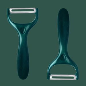Green stainless steel peeler with white ceramic blade and heart-shaped handle grip