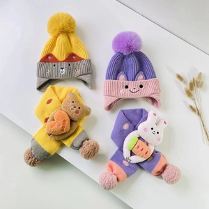 Detail of soft knitted winter hat and scarf set with cute 3D cartoon bear and rabbit