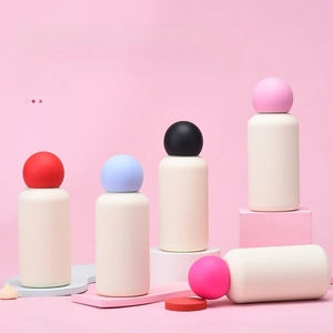 Multiple colorful mini 350ml vacuum insulated water bottles on geometric pedestals