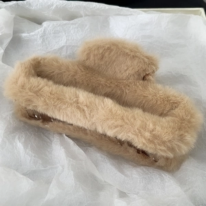 Detail of plush rectangular hair claw clip in khaki faux fur for autumn winter hairstyles