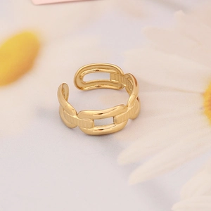 Macro shot of a gold chain-link open ring featuring a polished metallic texture finish