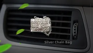 Detail of silver chain bag car perfume clip with sparkling rhinestones on air vent