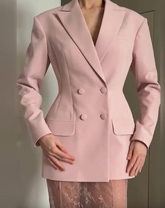 Detailed front view of a pink double-breasted blazer with a slim waist for women