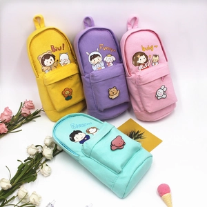 Cute schoolbag-shaped canvas pencil cases in four pastel colors with cartoon patches