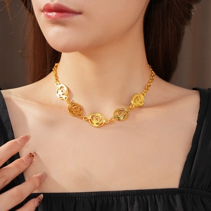 Close-up of vintage golden spiral flower necklace set on a model's neck