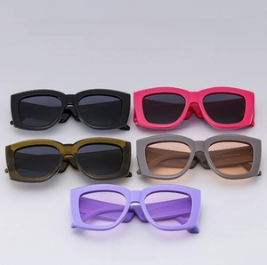 Macro detail of square sunglasses showing five color options and premium texture