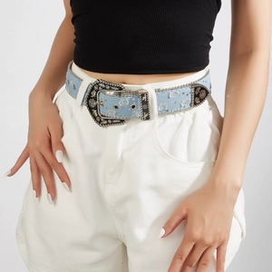 Vintage western blue denim belt with ornate silver buckle and rhinestones worn by model