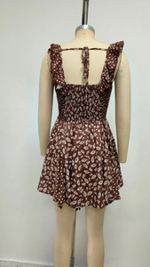 Detail of cross back straps and floral daisy print on a brown vintage summer dress