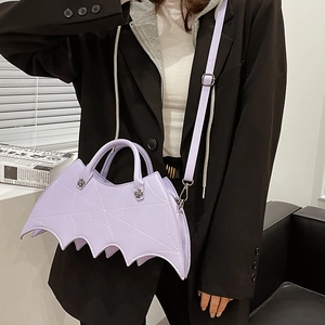 Detail of lavender PU leather bat-shaped bag with spider web stitching and cross metal decor