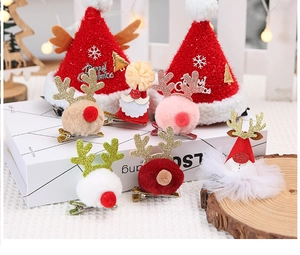 Detailed close-up of a festive set of reindeer antler and Santa hat plush hair clips