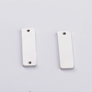 Detail of single and double hole stainless steel rectangular pendant tags in silver