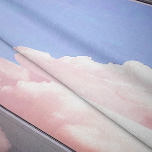 Close-up of bohemian wall tapestry with soft watercolor sunset cloud texture and finish