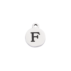 Detailed view of polished stainless steel round pendant with engraved black letter F