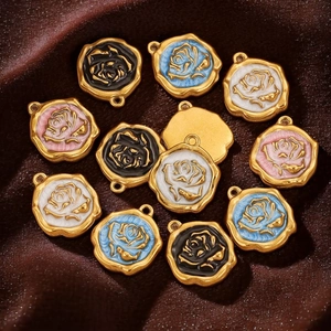 Detail of hexagonal enamel rose charms in gold finish for DIY jewelry crafting