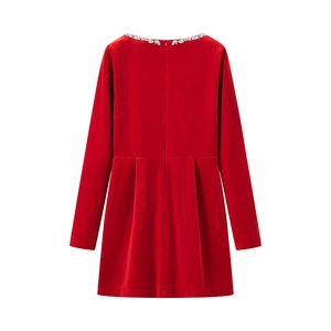 Detailed view of the sparkling rhinestone beadwork on red velvet long sleeve dress neckline
