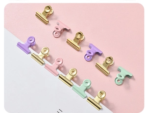 Close-up of pastel macaron binder clips in gold pink purple and green metal finish