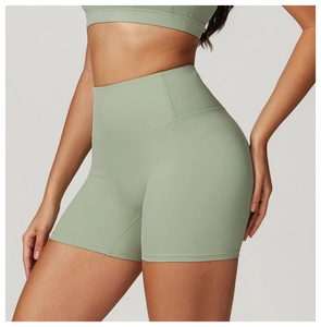 Detail of high-waisted seamless yoga shorts in Morandi green with peach lift design