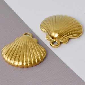 Detailed close-up of two golden 304 stainless steel shell pendants for DIY jewelry