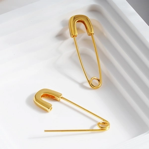 Polished gold paperclip earrings in high-shine stainless steel with minimalist modern design