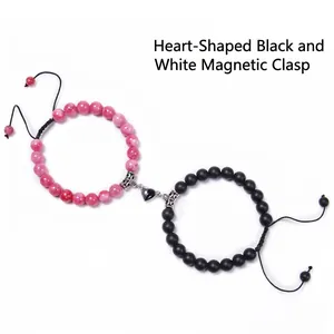 Detail of couple magnetic heart bracelet with pink textured and matte black beads
