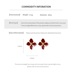 Detail view of vintage red flower earrings showing 2.4cm by 2.5cm size and 8.1g weight