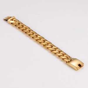 Macro detail of a heavy gold Cuban link bracelet with a secure wide clasp closure