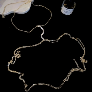 Macro shot of S-shaped crystal wave rhinestones on a delicate golden body chain