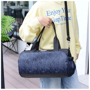 Detail of blue camo nylon travel bag featuring the Fashion logo and side mesh pocket