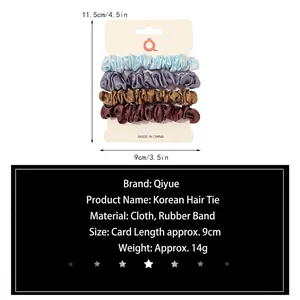 Set of four satin scrunchies in blue, grey, brown colors on a white display card